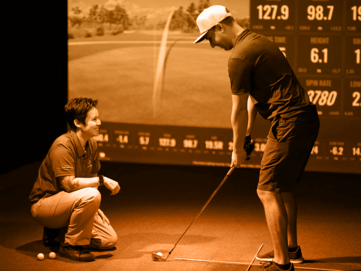 Person being coached on how to improve their golf swing.